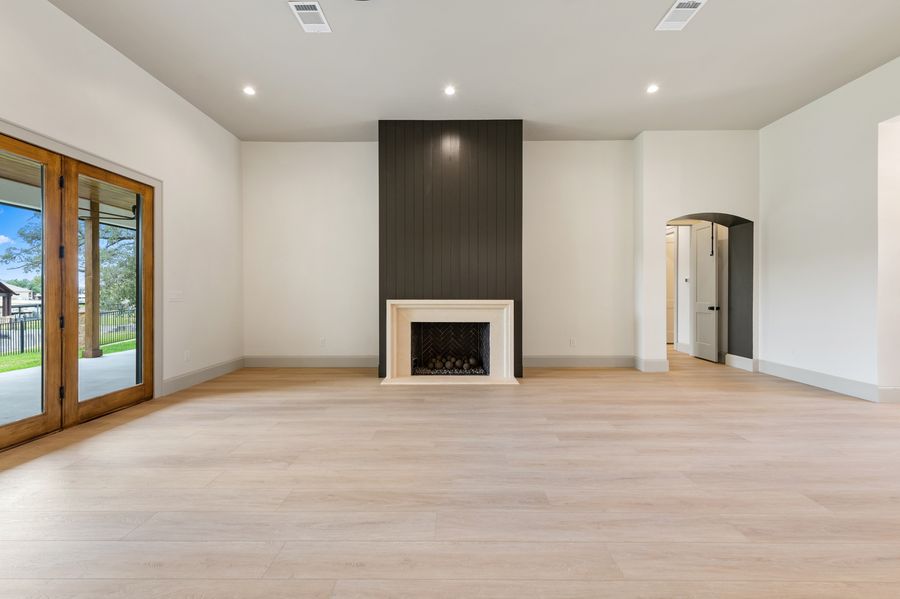 Living room with dark shiplap fireplace surround and limestone hearth