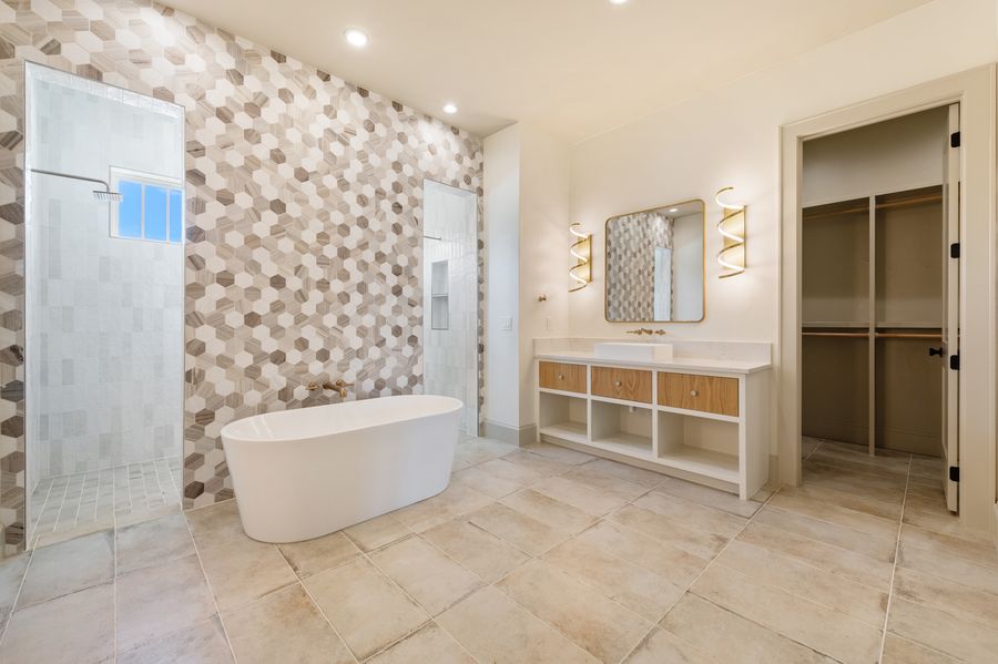 Bathroom detail with brass fixtures and natural stone