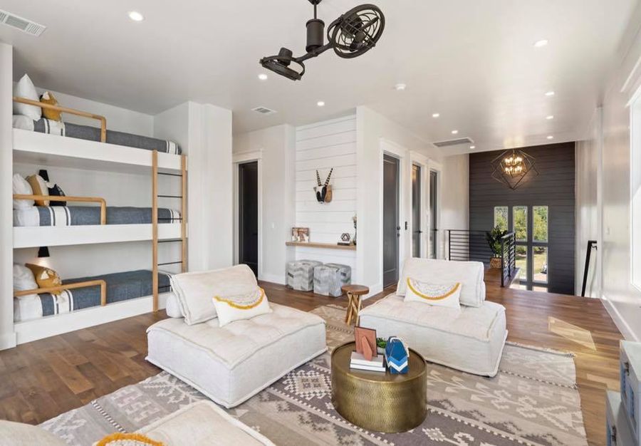 Downstairs game room with textured plaster and warm walnut