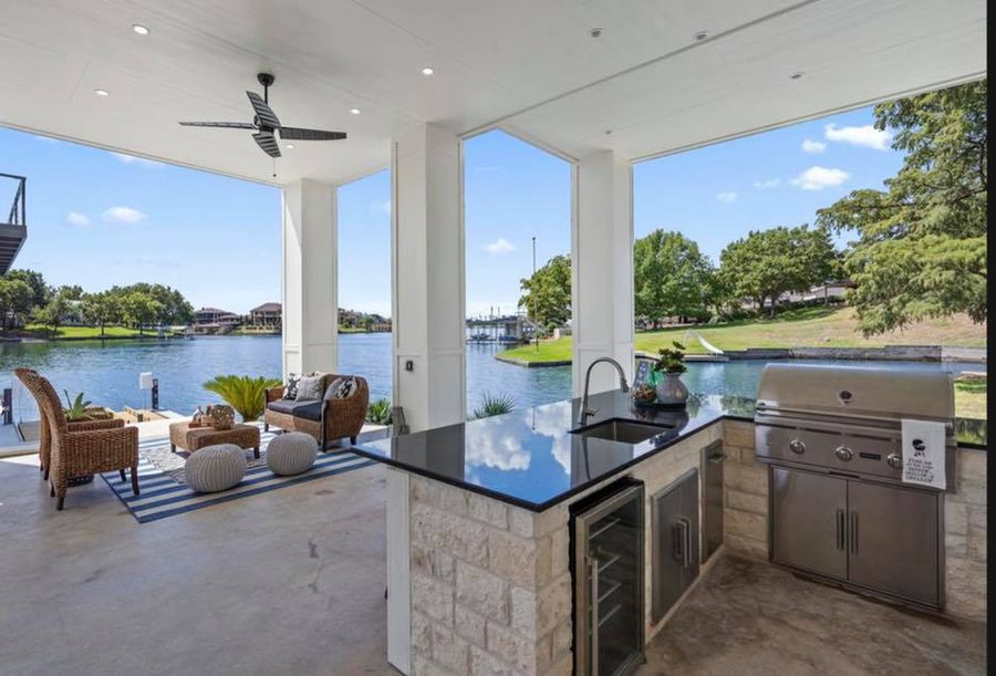 Outdoor kitchen with a built-in grill and concrete counters